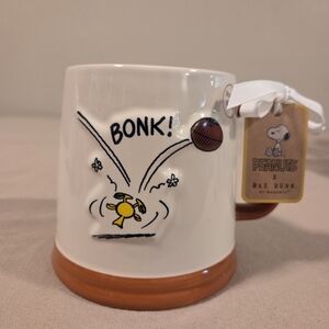 PEANUTS & RAE DUNN CERAMIC FOOTBALL MUG WITH WOODSTOCK GETTING BONKED